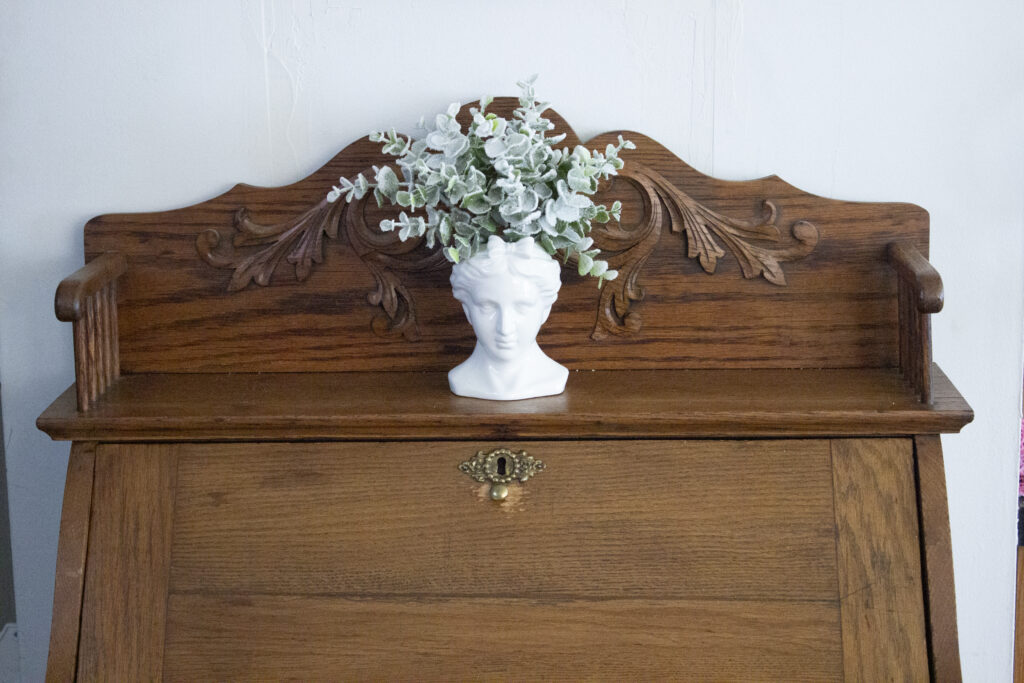 Vintage secretary desk styled with a bust vase from Hobby Lobby