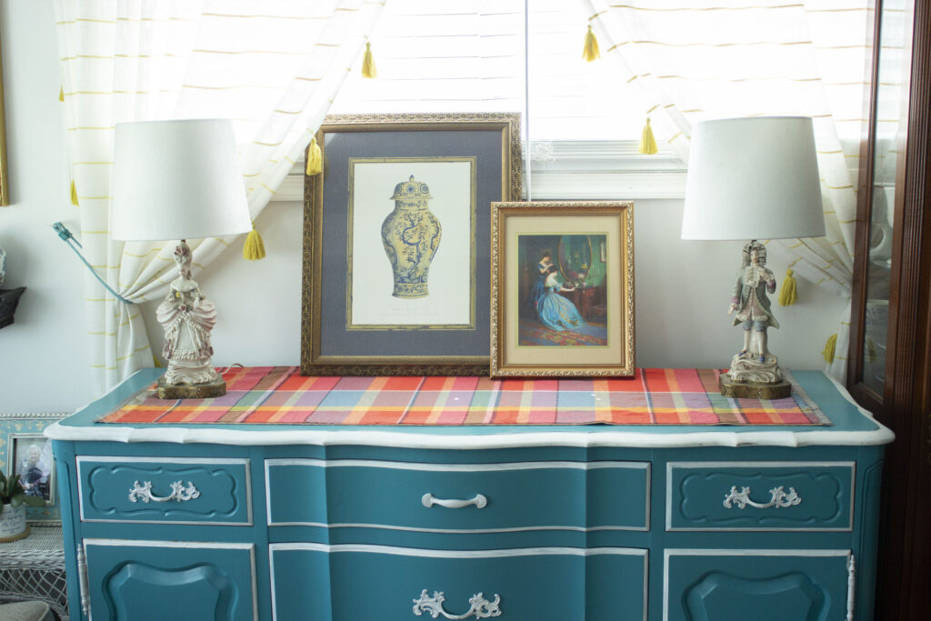 Turquoise blue buffet table  styled with French figurine lamps and art