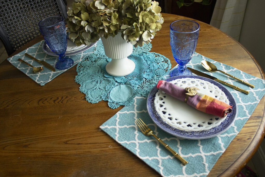 At Home Date Night Ideas: Tablescape for two featuring blue willow dishes and a hydrangea centerpiece