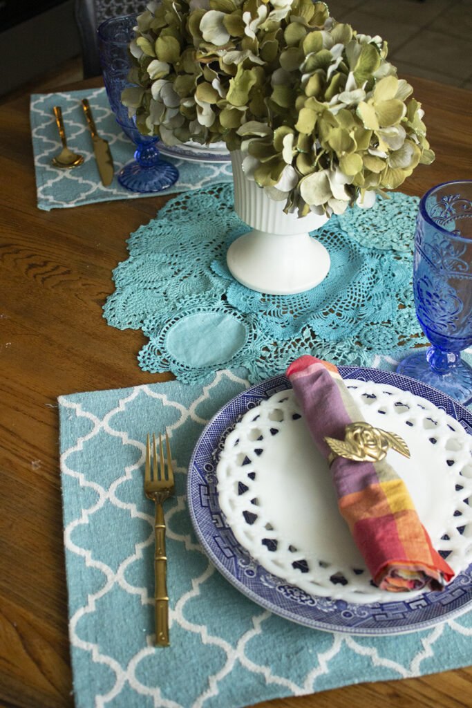 At Home Date Night Ideas: Tablescape for two featuring blue willow dishes and a hydrangea centerpiece