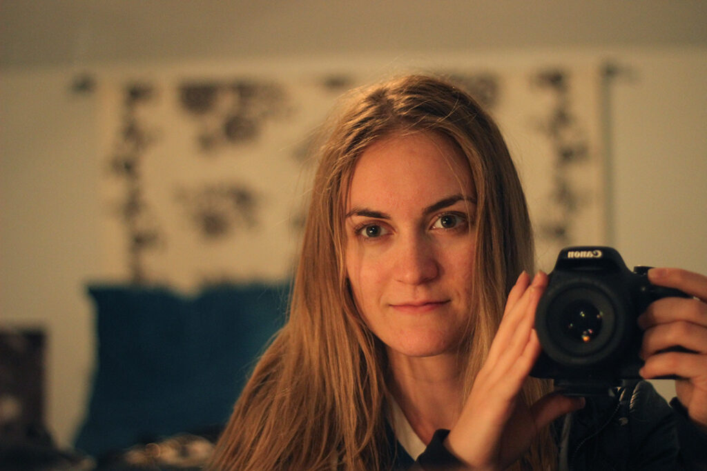 Woman with fine hair taking photo in mirror