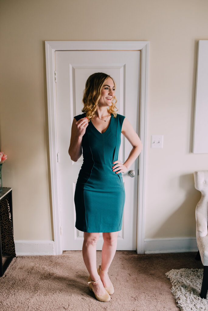 Woman in fitted green sheath dress