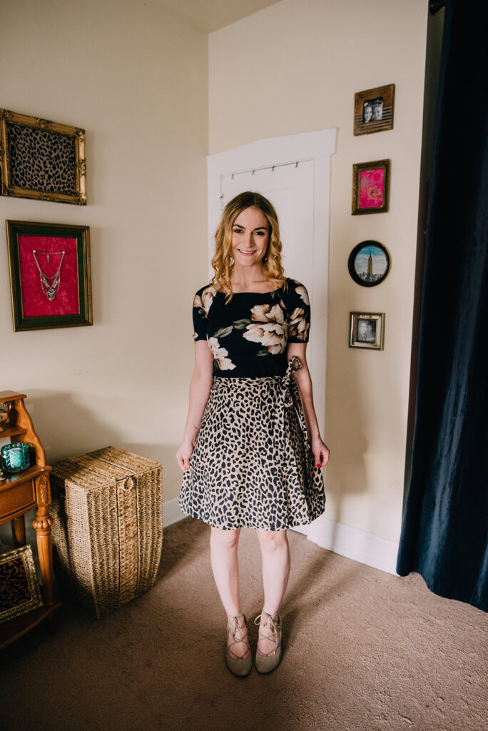 classy ways to dress and hourglass figure: Woman in floral top and leopard wrap skirt