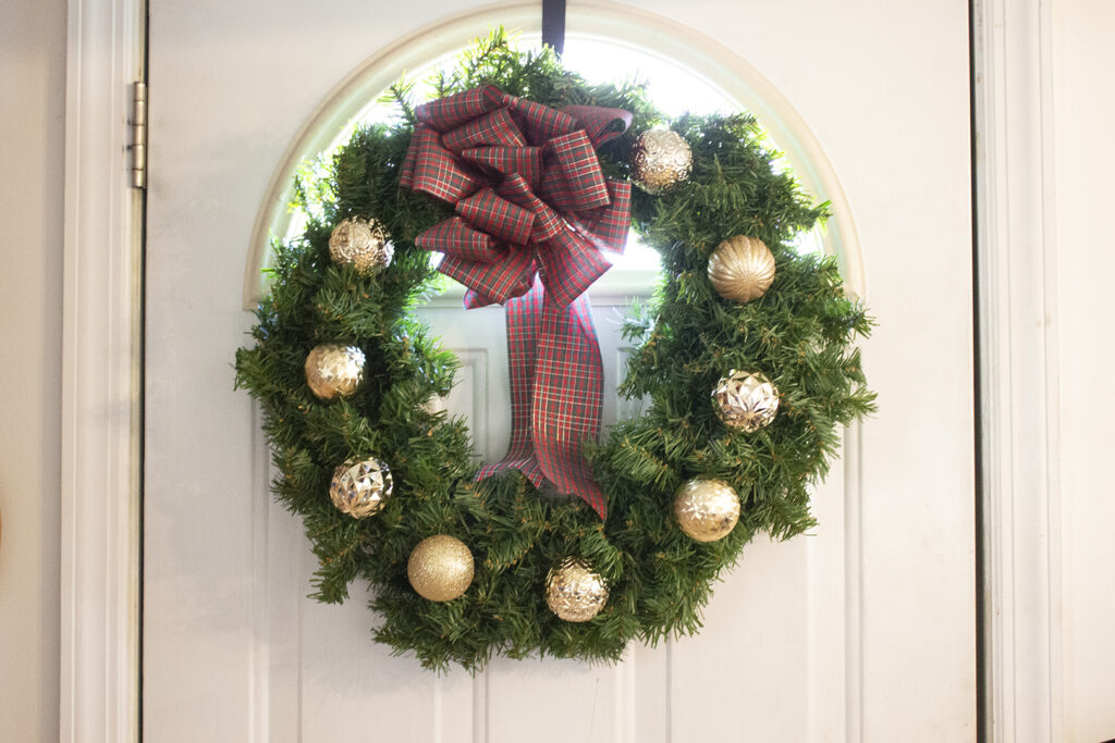 Wreath covered with gold Christmas ornaments