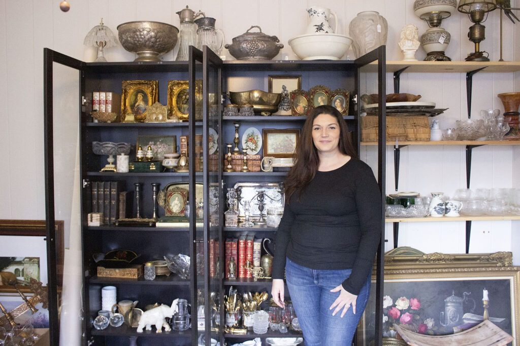 Vintage Seller Elisha M. in front of her store inventory