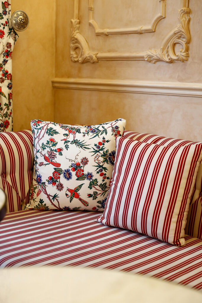 floral patterned and red striped pillows