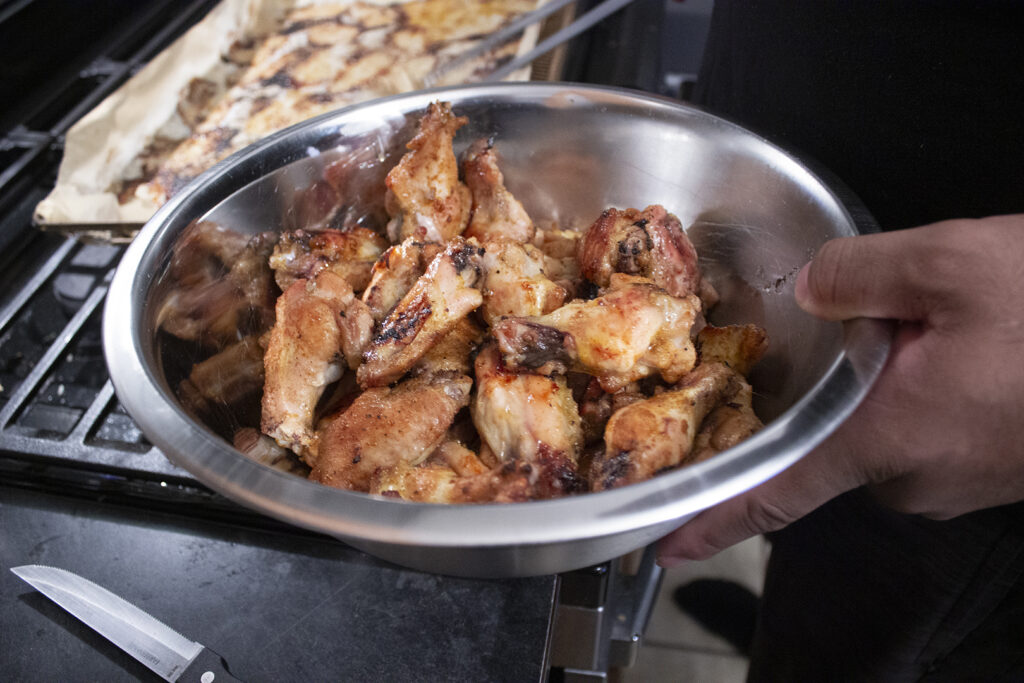 Chicken Wings Being Seasoned in a Bowl