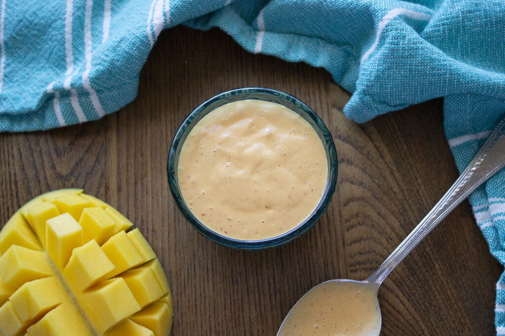 Mango Chipotle Mayo: Sauce with spoon and cut mango