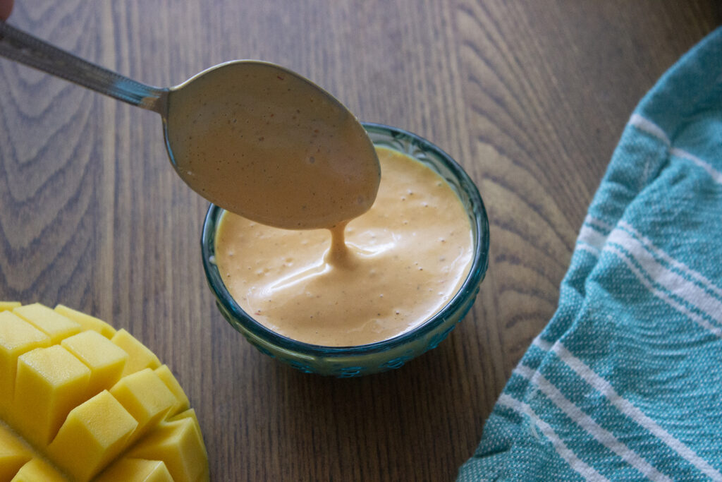 Mango Chipotle Mayo dripping from a spoon