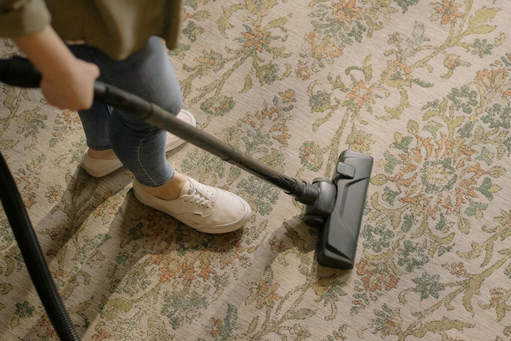 How to Refresh Your Home for Spring: Woman Vacuuming a Rug