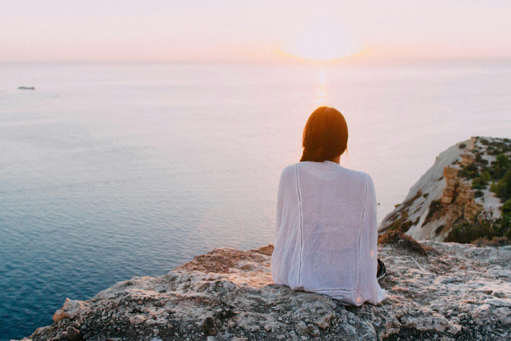 Habits to Improve Mental Health - Woman sitting by water