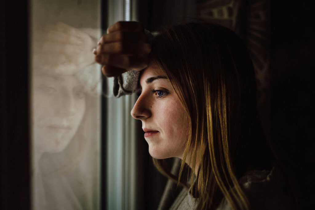 How to Overcome Intrusive Thoughts as a Christian: Woman Standing by Window