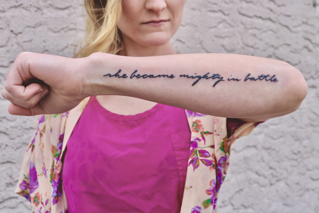 The Meaning of Hebrews 11: "She Became Mighty in battle" tattoo on arm