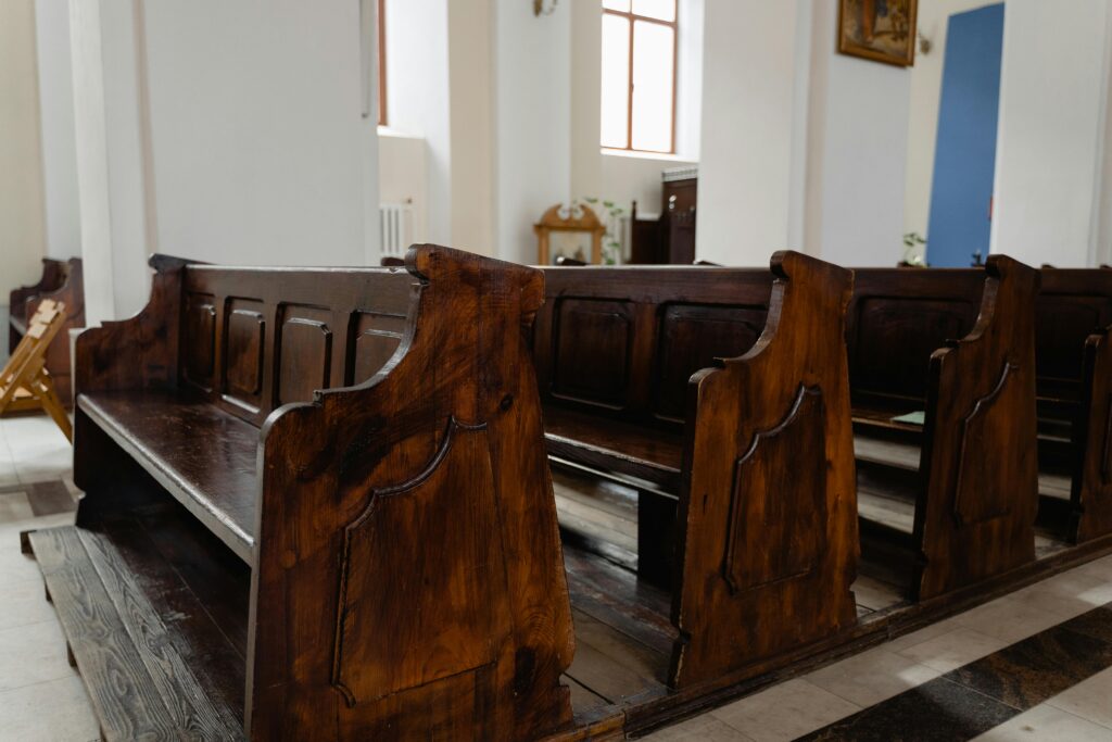 Fear of Man: Rows of empty wooden church pews