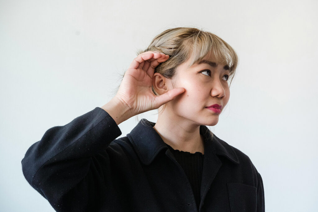 How to Hear God's Voice: Woman Holding Hand to Ear