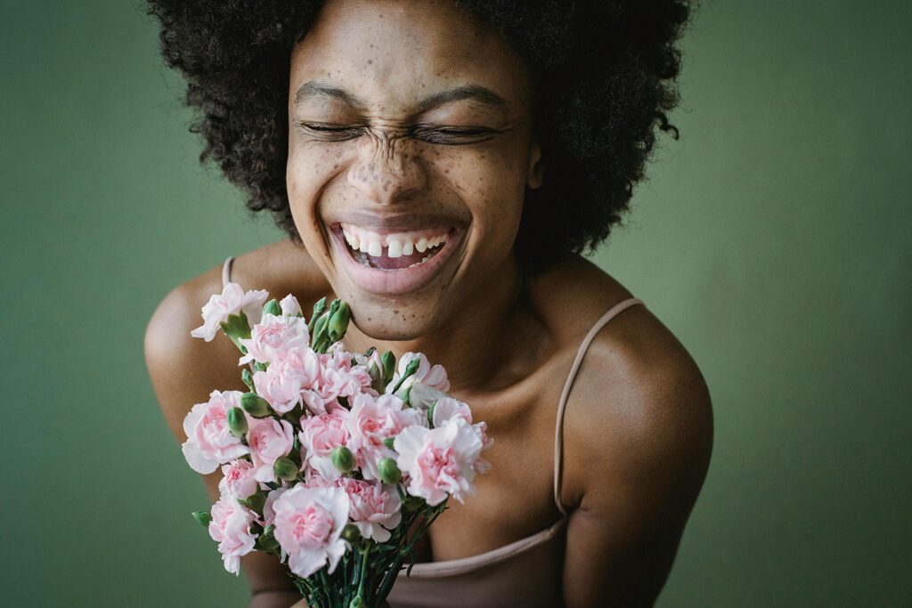 The Joy of the Lord: Happy woman holding bouquet of pink flowers