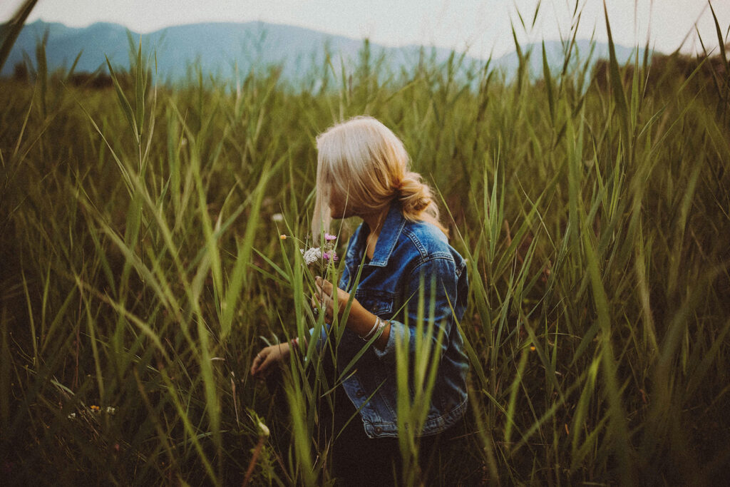 Protect Your Peace: Woman picking flowers in a field