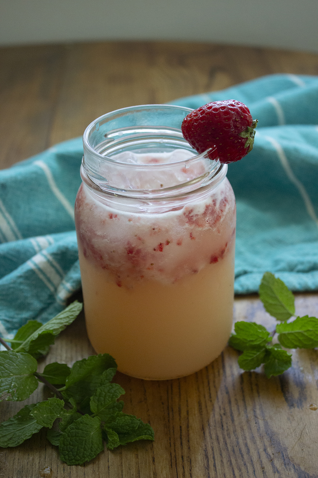 strawberry mocktail in jar with strawberry garnish