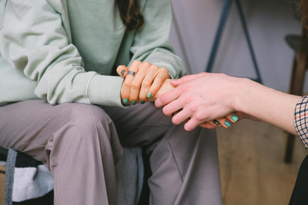 Mental Health and the Church: Women holding hands in support